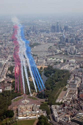 The Red Arrows aerobatic jets flanking an Envoy aircraft of the RAF during the King's Birthday flypast (Picture: MOD). The Red Arrows aerobatic jets flanking an Envoy aircraft of the RAF during the King's Birthday flypast (Picture: MOD).