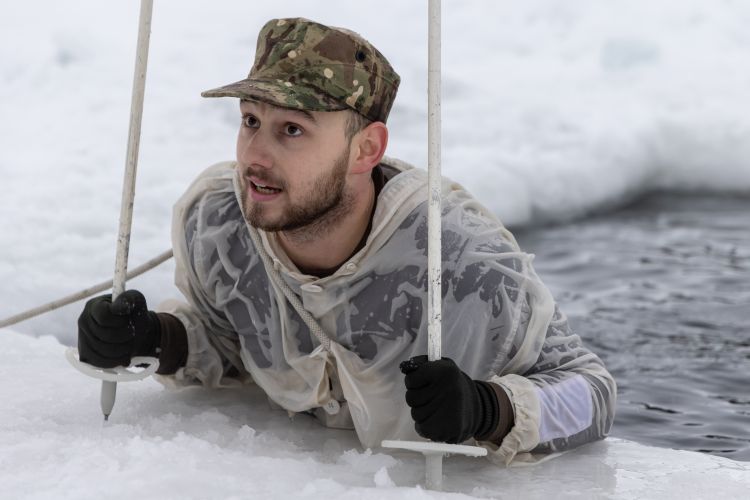 A member of the Force climbing out of the freezing water in Norway (Picture: Royal Navy).
