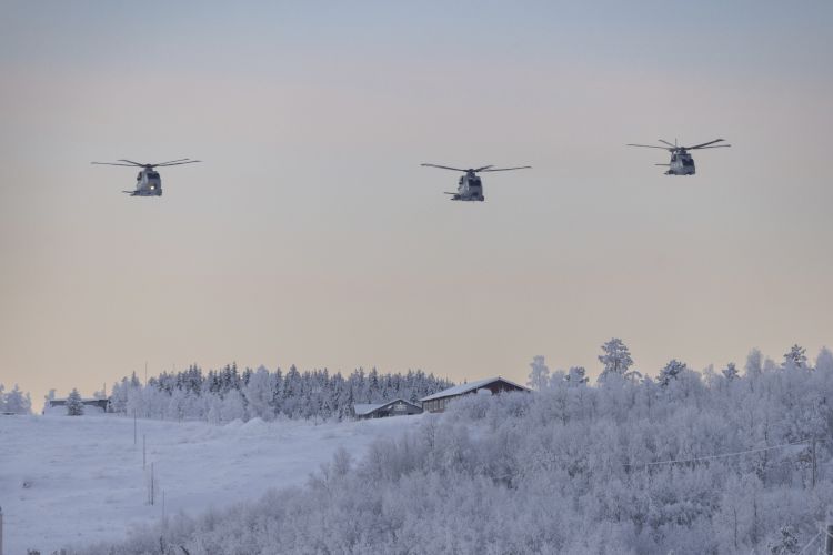 Three helicopters flying over the snow covered ground in Norway (Picture: Royal Navy).
