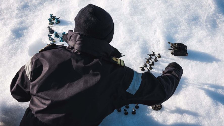 The Warhammer pieces are carefully set up for battle by Lt Talbot from HMS Protector 11022023 CREDIT Royal Navy.jpg