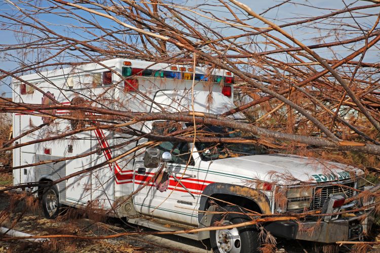 The damaged Fire Rescue building in Treasure Cay with the abandoned ambulance.