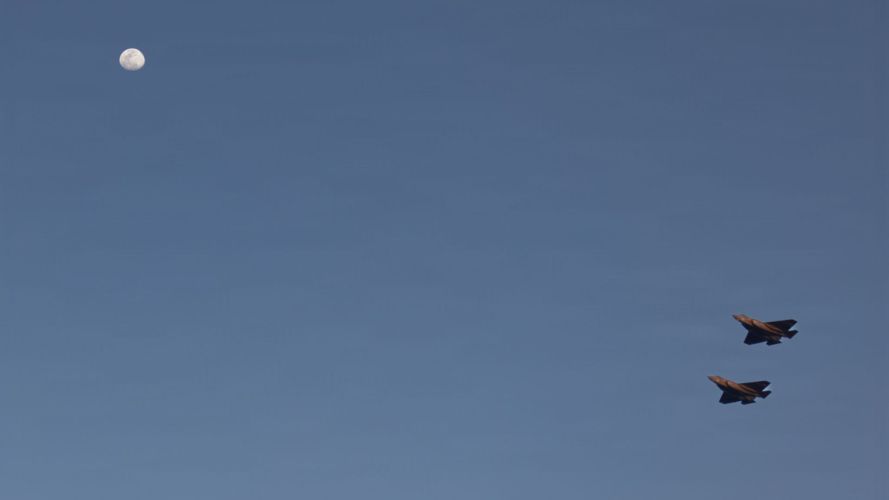 Two F-35C Lightning II perform a fly over above the carrier