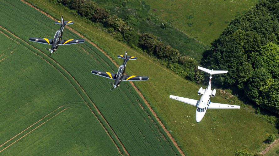 Two Texan T1 trainers and a Phenom jet trainer aircraft during QPJ Flypast Rehearsal – RAF College Cranwell 24052022 CREDIT MOD Crown Copyright.jpg
