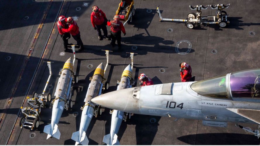 US Sailors prepare to load ordnance onto an FA-18F Super Hornet on the flightdeck of the carrier