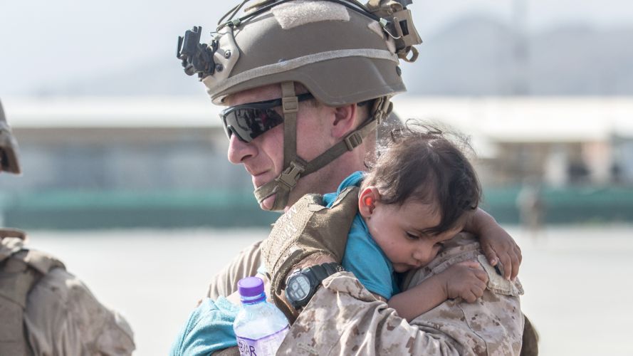 US Marine calms an infant during an evacuation