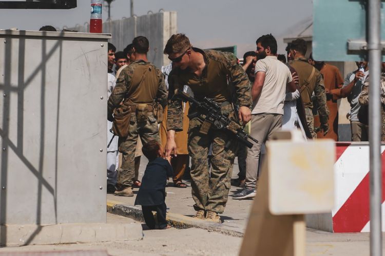 A US Marine plays with a child