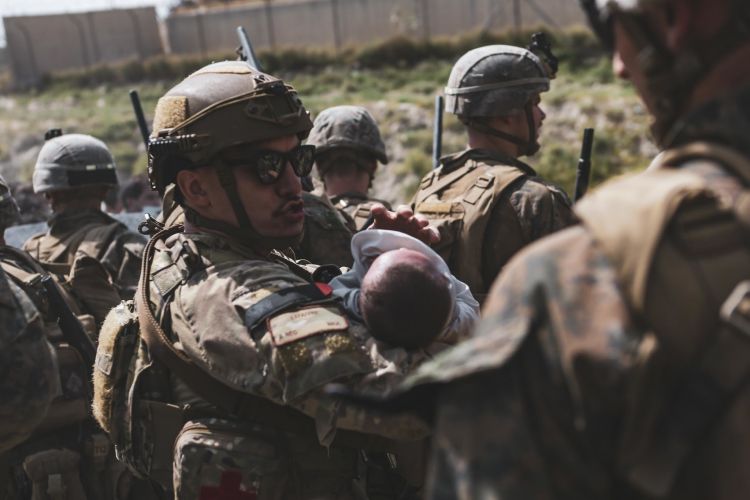 A US airman comforts an infant