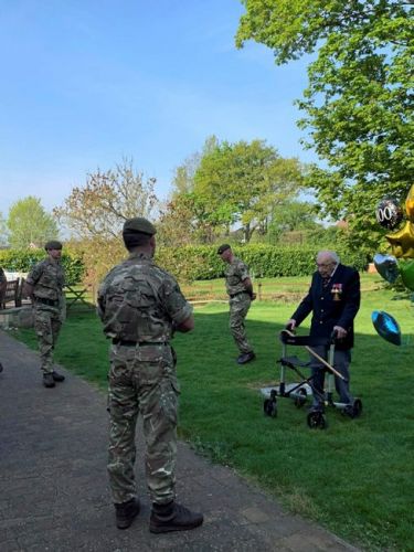 Veteran Captain Tom Moore talkig to 1st Battalion The Yorkshire Regiment soldiers