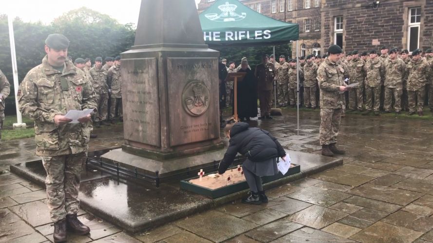 A young girl pays her respects on Armistice Day at 3 Rifles memorial garden, Redford Barracks Edinburgh.