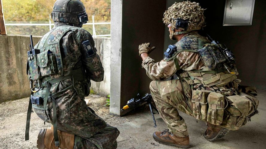 A soldier from C Company, the 1st Battalion Scots Guards talking a Republic of Korea soldier through the Arcs of fire during the Defensive phase on Exercise IMJIN WARRIOR (Picture: MOD).