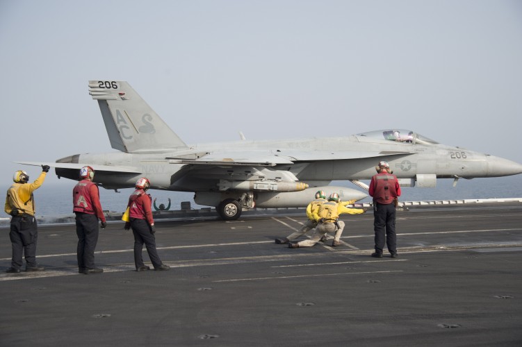 'Yellow shirts' guide the jets into position on the deck, while 'red shirts' handle fuel and ammunition