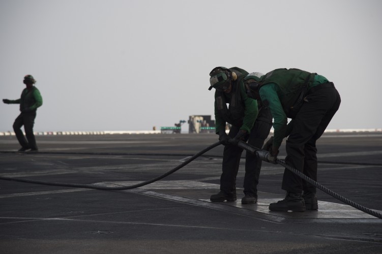 'Green shirts' operate the steam catapult and arrestor wires which trap the aircraft as they land