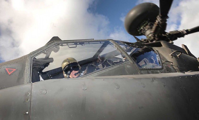 An Army Air Corps Apache pilot looks down at the camera during an exercise on the Barton Stacey Training Area (BSTA) near Winchester. 

Photo Crown Copyright