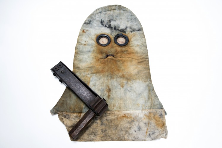 A 'PH' Helmet, used for protection against gas, and a rattle used to warn comrades of the presence of gas.