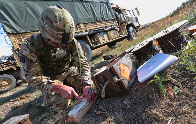 Lance Corporal Longhurst preparing explosives to be laid on a bridge.