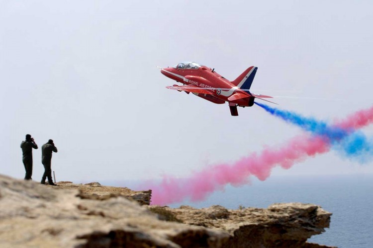 Red Seven of the Red Arrows screams past photographers waiting on a cliff edge during a practice display over RAF Akrotiri in Cyprus.

Photo Crown Copyright 2008