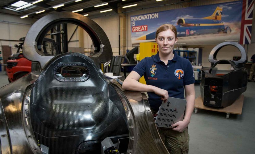 Cpl Chloe Rhodes (Avionics Tech) next to the Bloodhound Supersonic Car.