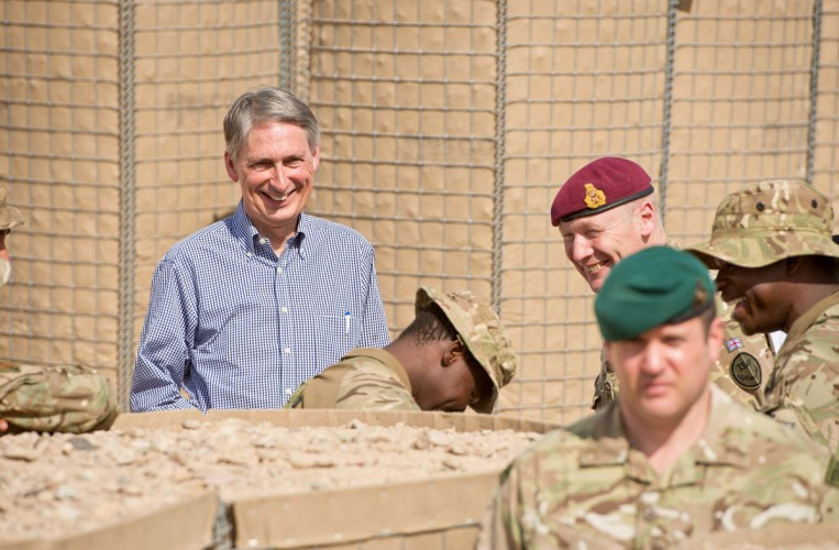 Phillip Hammond MP, Secretary of State for Defence, shares a joke with soldiers of 4 SCOTS Bn who have lived within PB Sterga 2 for over six months