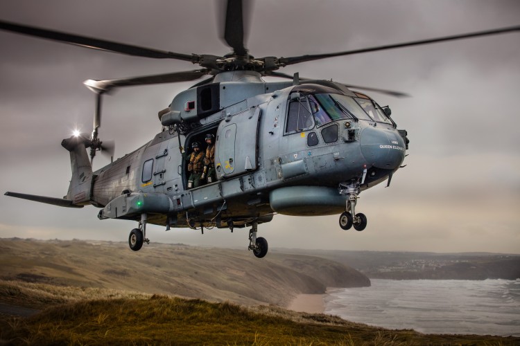 Pictured are 820 Naval Air Squadron making the most of the Cornish Landscape to hone their Fly Navy skills.  A local photographer, Greg Caygill, caught the Merlin Mk2 helicopter in the sand dunes near Perranporth beach. 