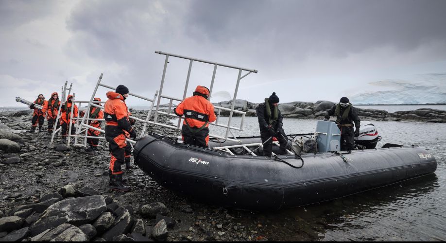 HMS Protector crew members transporting equipment from their boats (Picture: Royal Navy).