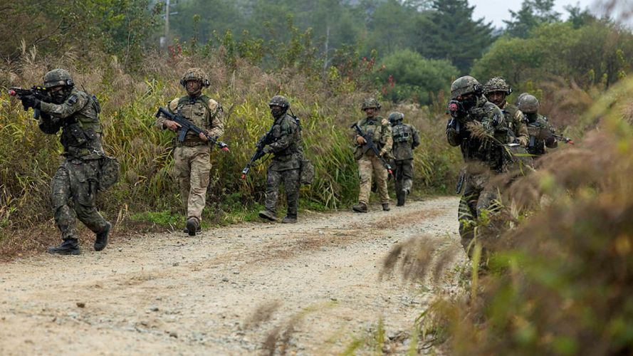Soldiers from C Company, the 1st Battalion Scots Guards and the Republic of Korean Army Patrolling along a dirt track during the defensive phase of Exercise IMJIN WARRIOR (Picture: MOD).