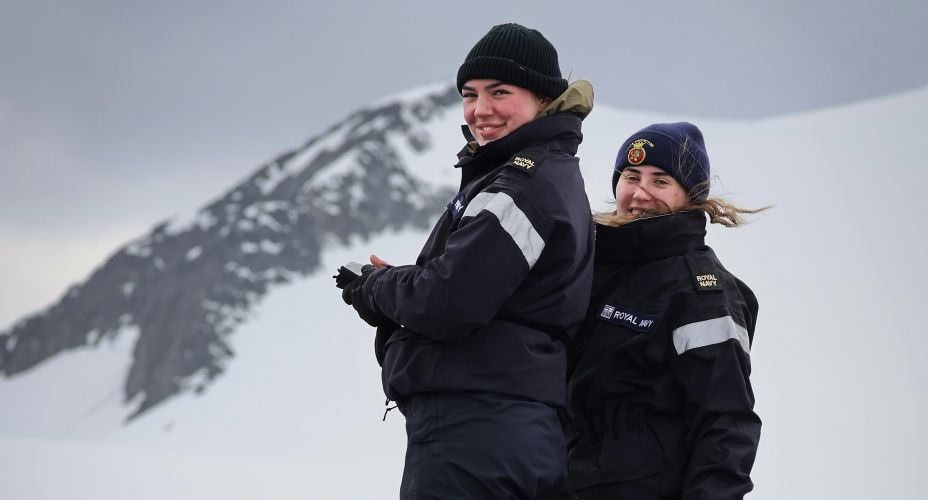 Two members of the crew of HMS Protector smiling in the snow (Picture: Royal Navy).