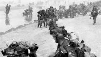 British soldiers struggle ashore on Sword beach 
