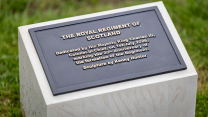 The commemorative plaque of the monument which says that it was unveiled on July 1st and designed by Kenny Hunter