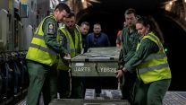 Royal Navy 815 Squadron service personnel loads the Wildcats' rotor blades onto the back of the C-17 - the blades are made of composite materials and are durable, but still need careful handling