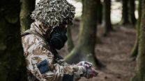 Despite the summer heat, the signallers had to don respirators and protective clothing as part of their CBRN training - this is worn over their uniform, not instead of it