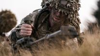  This signaller is using a handheld metal mine detector to ensure the ground is free of any traps laid by the opposing force