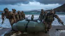 With the boat pulled up on the sand, the gunners from 148 (Meiktila) Commando Forward Observation Battery were in full tactical mode as they made their way to their position
