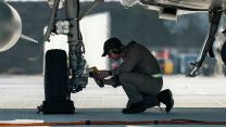 An aircraft technician from 3 (Fighter) Squadron checks the brake temperature on a Typhoon FGR.4 after landing at Borcea 86th Air Base