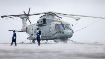 Aircraft handlers secure a Merlin Mk2 on the flight deck of HMS Prince of Wales - the Mk2 is principally an anti-submarine warfare helicopter, although it can carry out other roles, such as search and rescue and maritime patrol