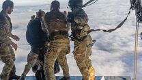 A nurse and a paratrooper from 16 Air Assault Brigade make a tandem jump off the ramp of the Atlas - a jump like this allows personnel who are not para-trained to make a drop where they are needed