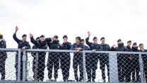 The personnel wave as they return home from CSG25