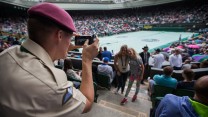 Private O'Brien takes a picture for spectators on Centre Court