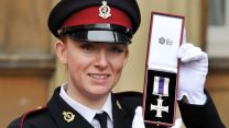 Cpl Sarah Bushbye holds her Military Cross, presented to her by Queen Elizabeth II in November 2010 (Picture: PA Images)