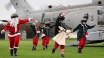 Father Christmas and his elves pay a visit to some schoolchildren - with a little help from a Royal Navy Merlin from RNAS Yeovilton