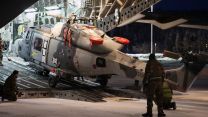 847 Naval Air Squadron engineers offload an Army Wildcat HMA Mk2 helicopter from an RAF C-17A Globemaster at Royal Norwegian Air Force Base Bardufoss