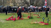 Crowds gather in the rain at the Edinburgh Garden of Remembrance to mark Armistice Day