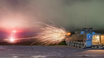 A Warrior IFV opens fire with its 7.62mm chain gun during a gunnery course to qualify personnel as Armoured Cavalry Troop Leaders or Warrior Platoon Commanders - note how the spent cases are ejected forwards