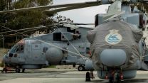 Merlin Crowsnest airborne surveillance and control system helicopters await their next mission while deployed to RAF Akrotiri - the helicopters are from 820 Naval Air Squadron, whose emblem is a flying fish