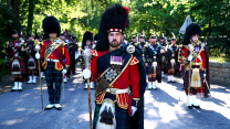 The pipe band of 3 & 4 SCOTS, Royal Regiment of Scotland march through the gates of Balmoral 