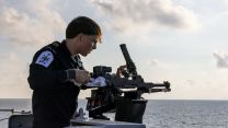 HMS Richmond's crew pictured cleaning their weapons during the rare transit
