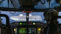 The crew of a Merlin get a good look at the British and Italian F-35Bs embarked on HMS Prince of Wales as the helicopter approaches the carrier nose-down