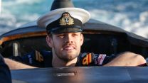 A crewmember of hunter-killer submarine HMS Anson pops his head out as the boat arrives in Australia for an historic visit to strengthen the UK's commitment to the security of the Indo-Pacific
