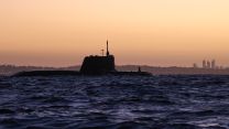 HMS Anson prepares to enter HMAS Stirling, a Royal Australian Navy base in Western Australia, with the state capital Perth in the background