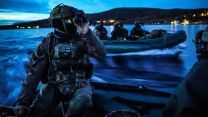 In Norway, a Royal Marine from 40 Commando uses his night vision capabilities to navigate to shore