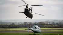 RAF Chinook approaches as a French Air and Space Force Fennec sits on the ground during Exercise Pegasus Exchange 26 